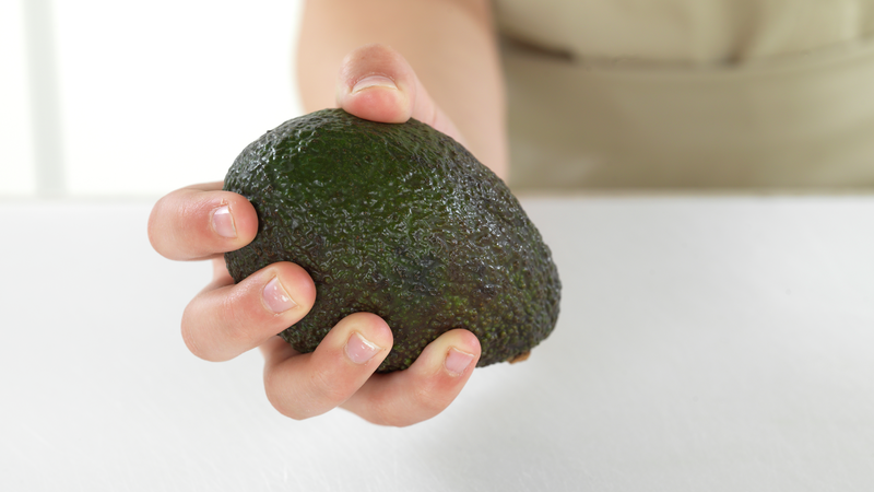 Finn frem en moden avokado. Når du holder den i hånden skal den kjennes fast, men gi litt etter når du klemmer forsiktig på den.